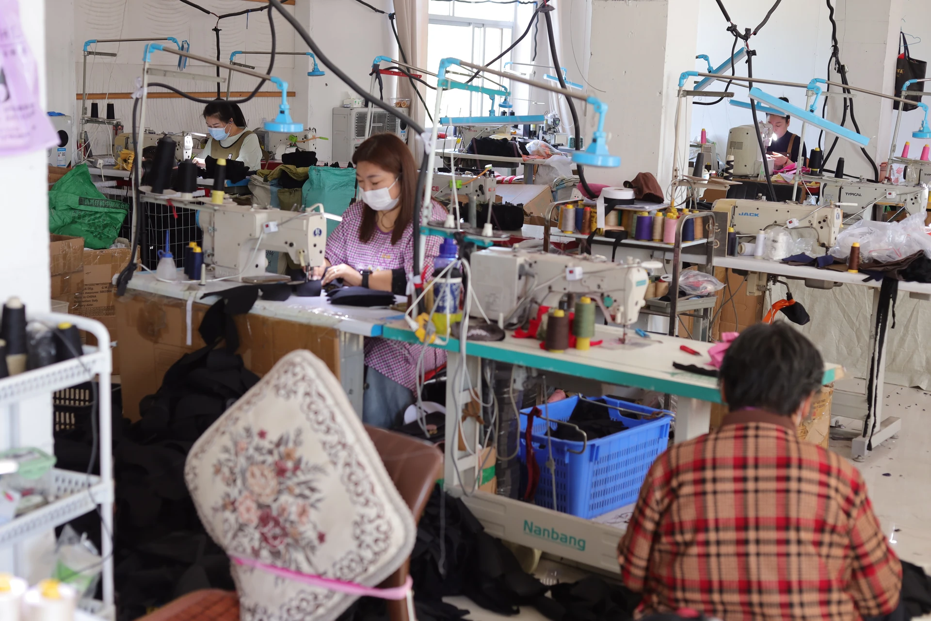 Sewing workstations used for cap panel assembly