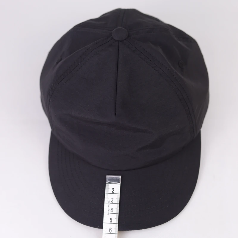 Front reference of a dark cap with a compact curved visor